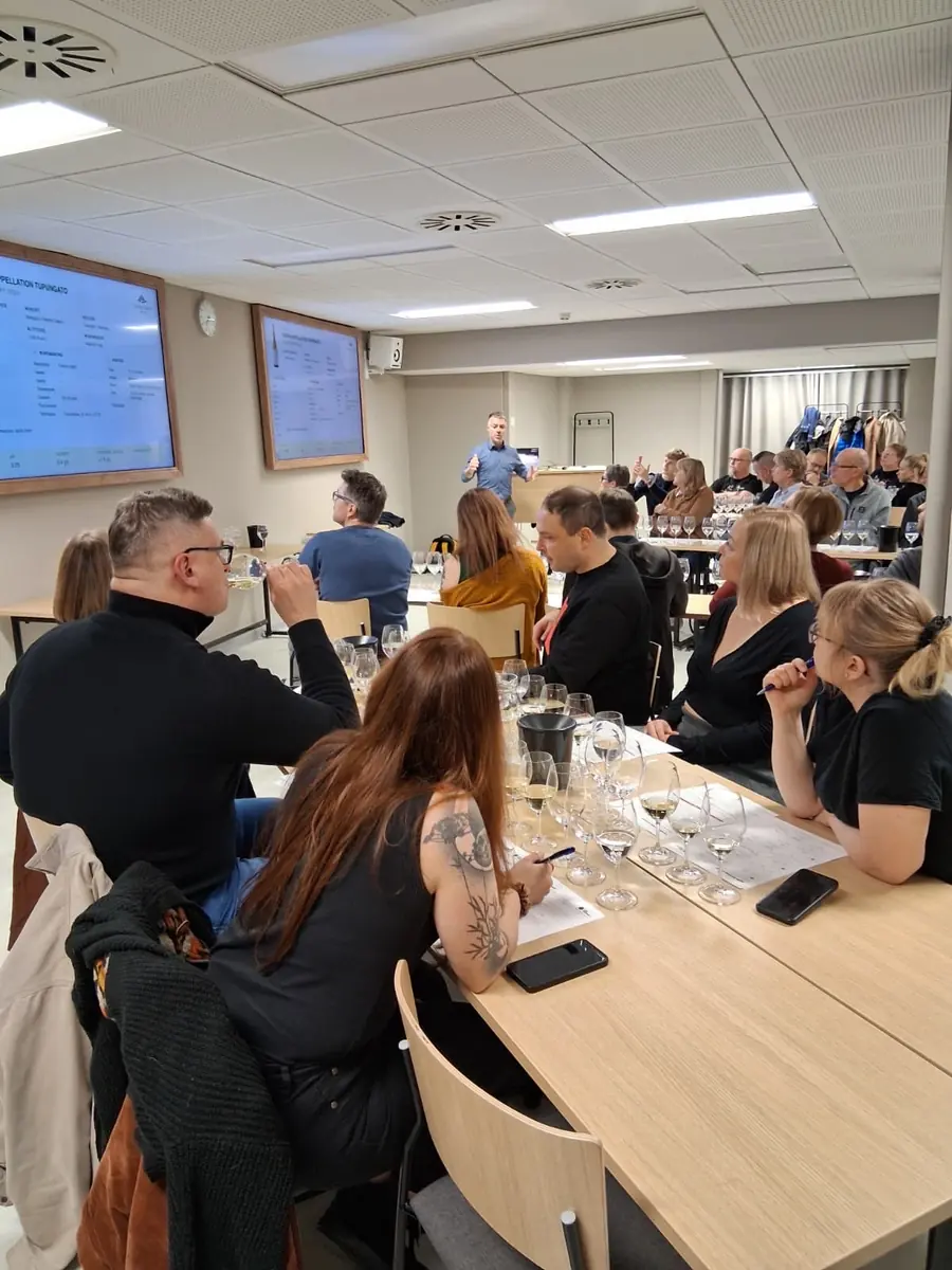 Tasters concentrating on their glasses and notes